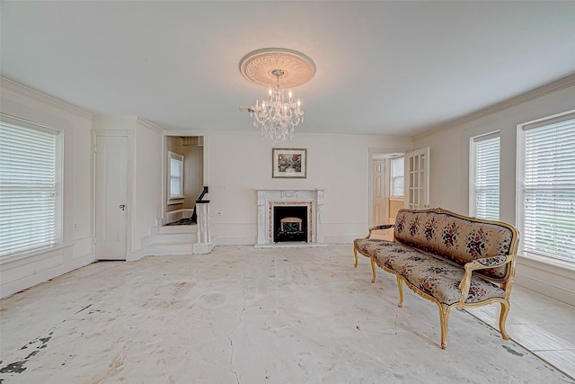 living room featuring a premium fireplace, crown molding, and a chandelier