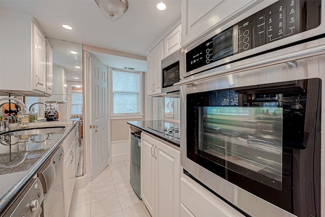 614 Clear Lake Rd, Kemah, TX 77565 - kitchen featuring a sink, white cabinets, appliances with stainless steel finishes, and recessed lighting