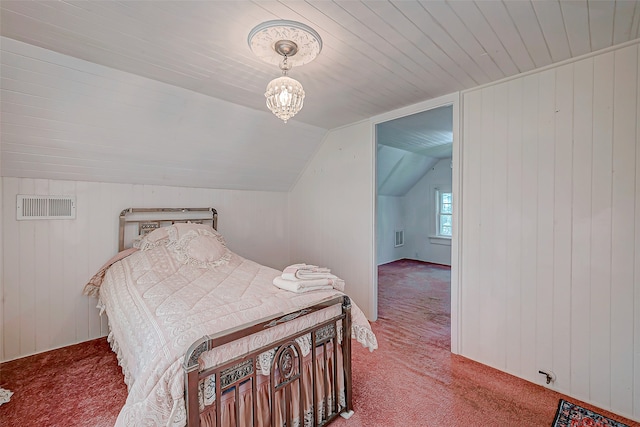 carpeted bedroom featuring lofted ceiling, a chandelier, and wood walls