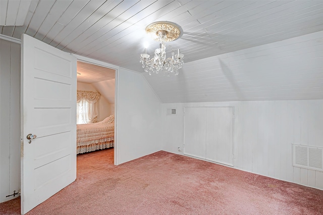 bonus room featuring vaulted ceiling, carpet, and an inviting chandelier