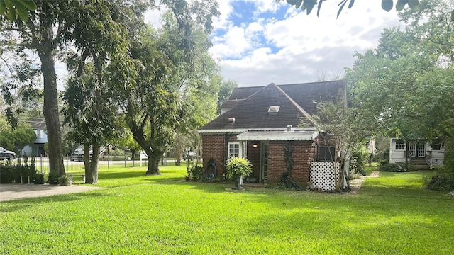 614 Clear Lake Rd, Kemah, TX 77565 - rear view of property with a lawn and brick siding