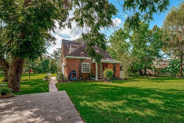 614 Clear Lake Rd, Kemah, TX 77565 - view of front of house with a front lawn and brick siding