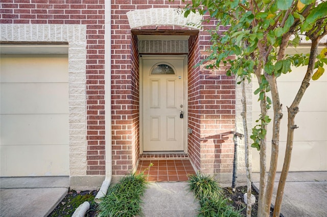 doorway to property with a garage