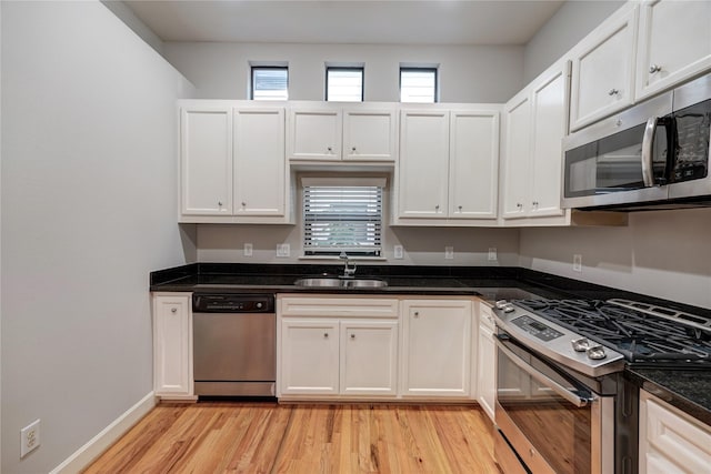 kitchen with plenty of natural light, sink, light wood-type flooring, and stainless steel appliances