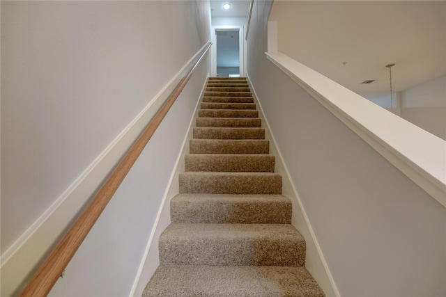 stairs featuring carpet floors