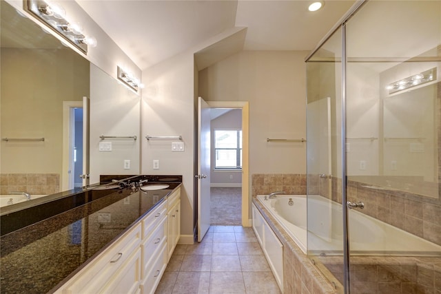 bathroom featuring vanity, tile patterned floors, and tiled tub