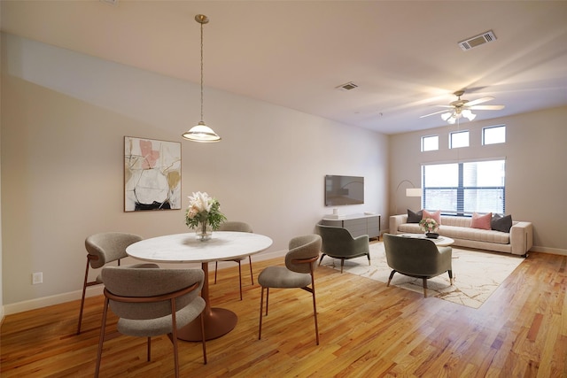 dining room featuring light hardwood / wood-style flooring and ceiling fan