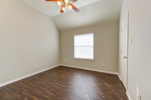 spare room featuring ceiling fan, dark hardwood / wood-style flooring, and vaulted ceiling