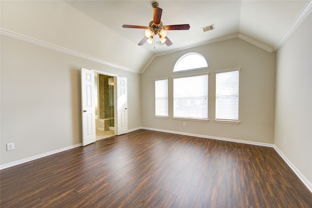 spare room featuring dark hardwood / wood-style floors, ceiling fan, crown molding, and vaulted ceiling