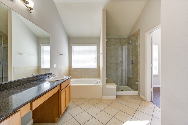 bathroom featuring tile patterned floors, vanity, plus walk in shower, and vaulted ceiling