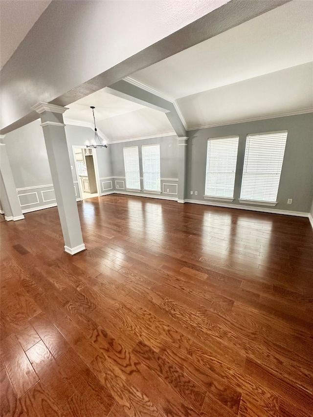 unfurnished living room featuring dark hardwood / wood-style flooring, lofted ceiling, and a wealth of natural light