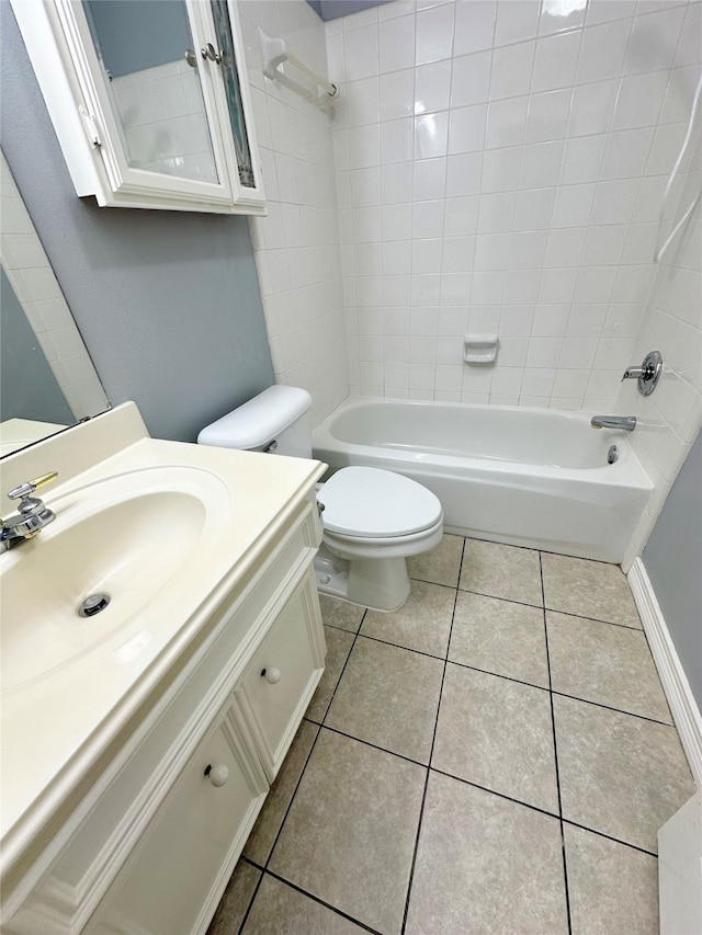 full bathroom with tile patterned floors, vanity, tiled shower / bath combo, and toilet