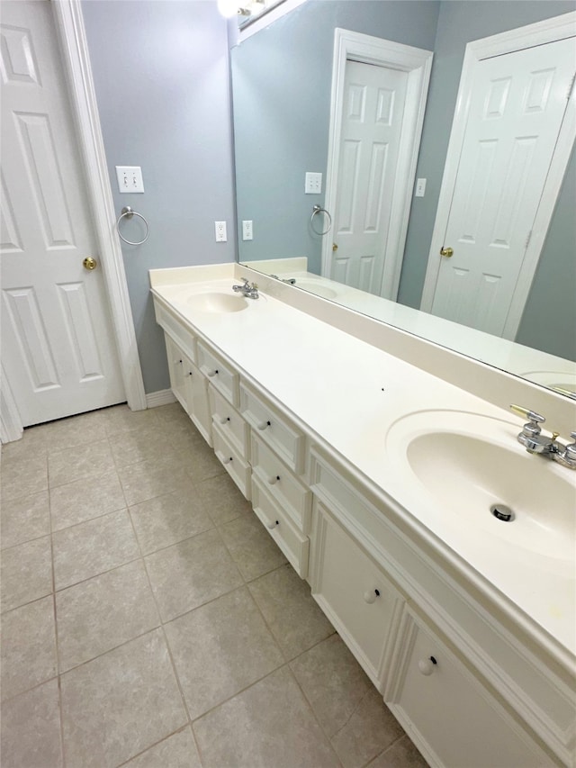 bathroom with tile patterned flooring and vanity