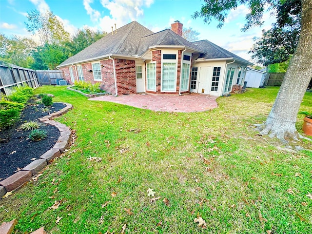 back of house with a yard and a patio area