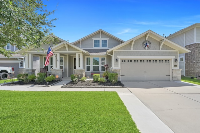 craftsman inspired home featuring covered porch, a garage, and a front lawn