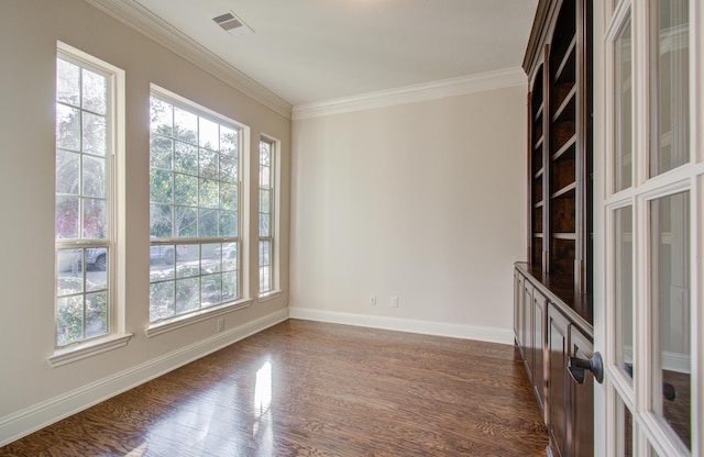 empty room with ornamental molding and dark wood-type flooring