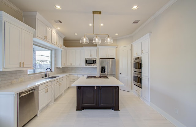 kitchen featuring decorative backsplash, white cabinetry, a kitchen island, and appliances with stainless steel finishes