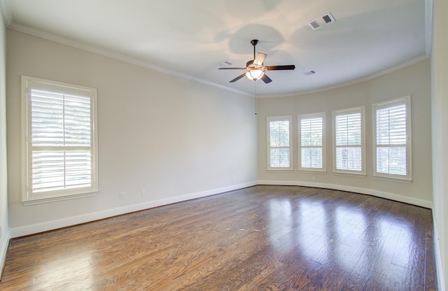 spare room featuring dark hardwood / wood-style flooring, ceiling fan, and crown molding