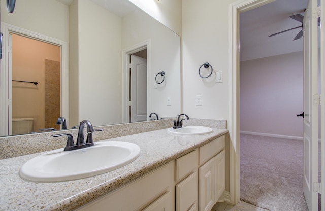 bathroom featuring ceiling fan, toilet, and vanity