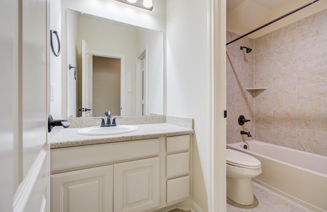 full bathroom featuring tile patterned floors, tiled shower / bath combo, toilet, and vanity