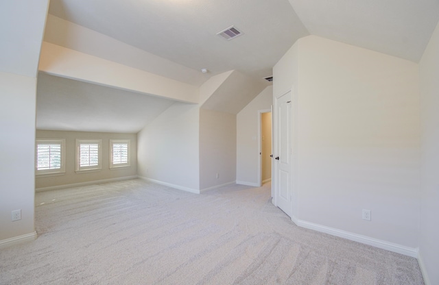 bonus room featuring light carpet and lofted ceiling