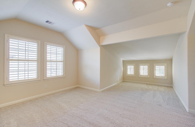 bonus room featuring light colored carpet and lofted ceiling