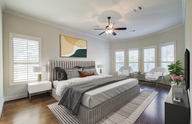 bedroom featuring ceiling fan, dark hardwood / wood-style flooring, crown molding, and multiple windows