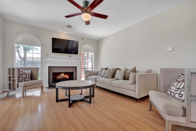 living room with ceiling fan and light hardwood / wood-style floors