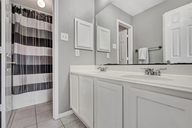 bathroom with tile patterned flooring and vanity