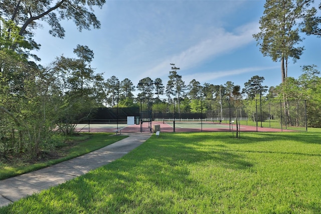 surrounding community with a yard and tennis court