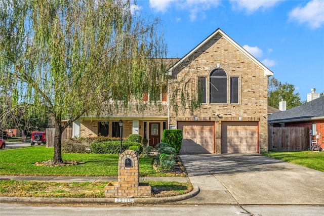 view of front of property with a front yard and a garage