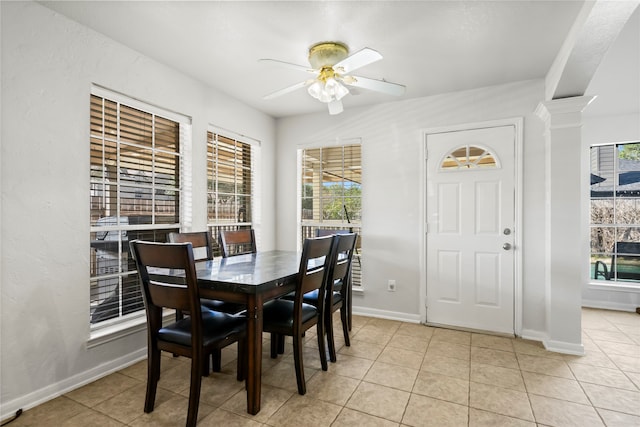 dining area with light tile patterned floors, ornate columns, and ceiling fan