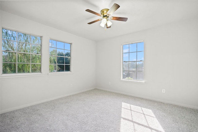 carpeted spare room with ceiling fan