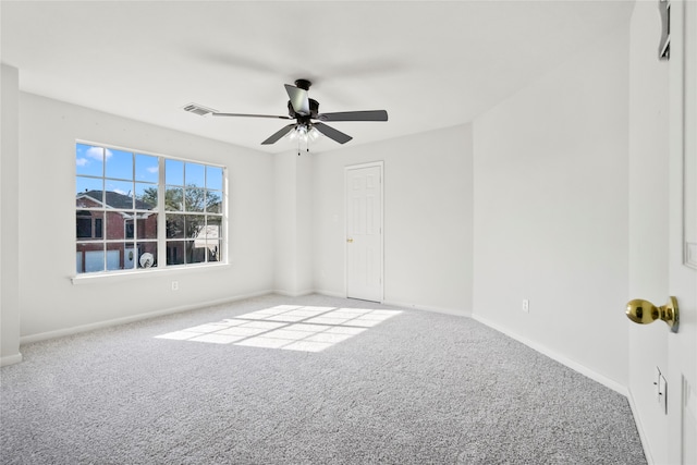 carpeted empty room featuring ceiling fan