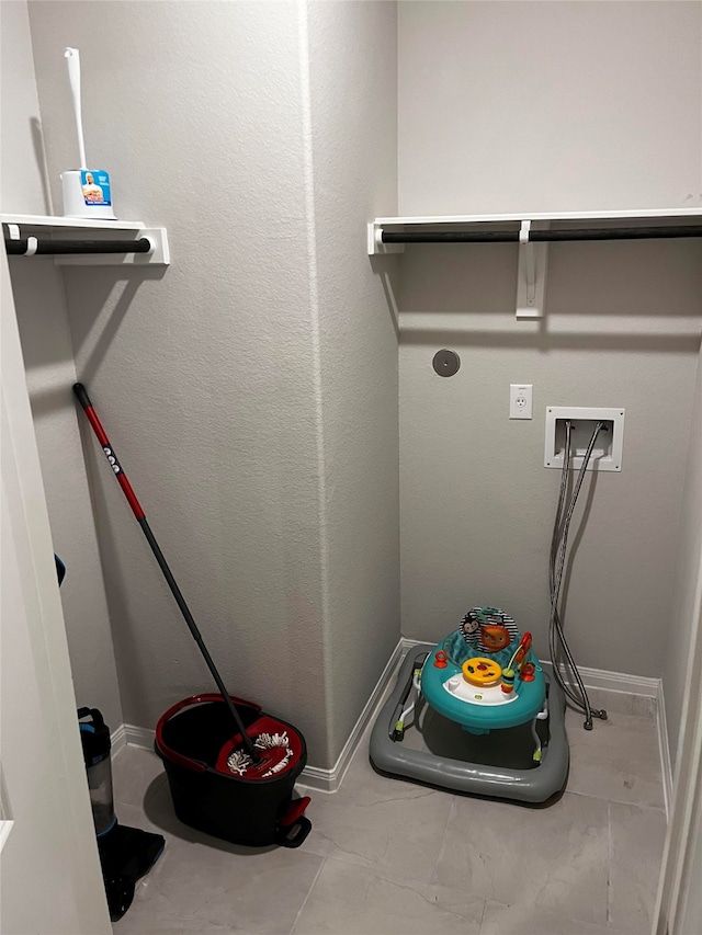 laundry room with washer hookup, electric dryer hookup, and light tile patterned flooring