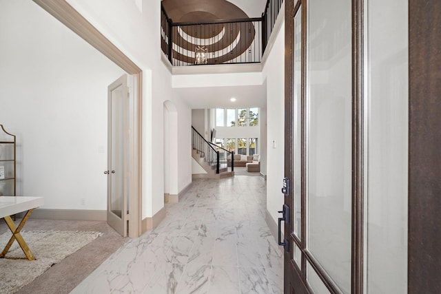 entrance foyer featuring a high ceiling and french doors