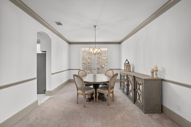 dining space featuring a notable chandelier, light colored carpet, and crown molding