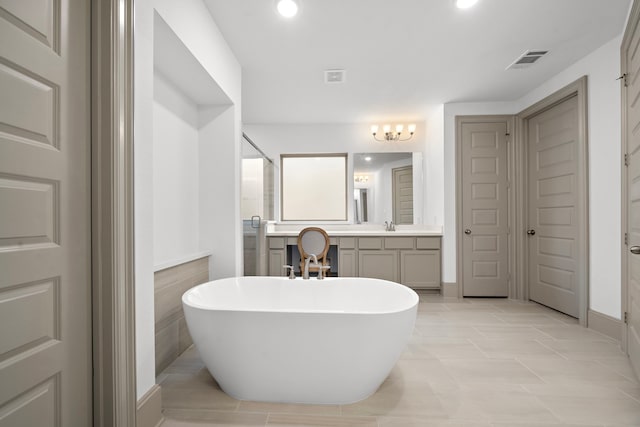 bathroom featuring tile patterned floors, separate shower and tub, vanity, and tile walls