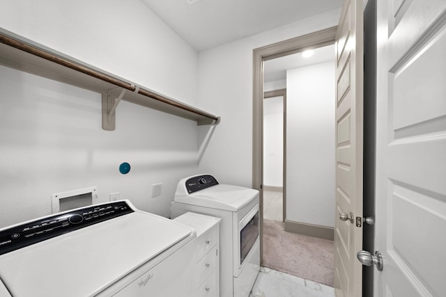 washroom featuring washing machine and dryer and light colored carpet