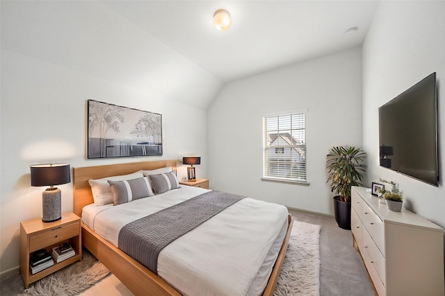 carpeted bedroom featuring lofted ceiling