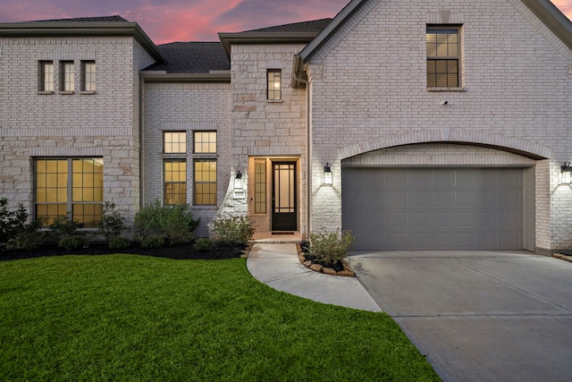 view of front of house with a lawn and a garage