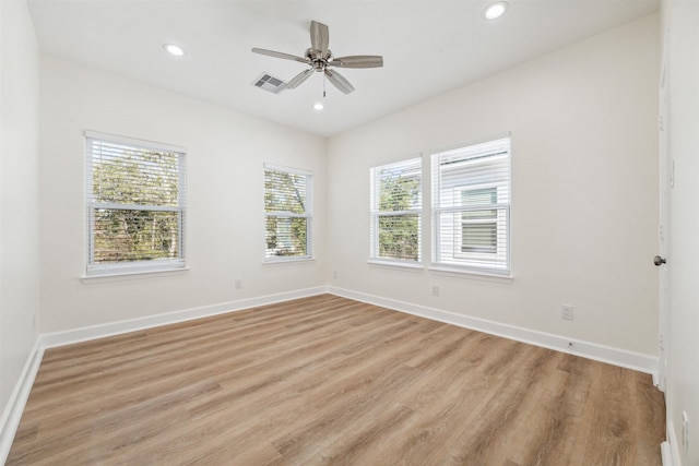 unfurnished room featuring ceiling fan, a healthy amount of sunlight, and light hardwood / wood-style floors