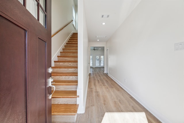 foyer featuring light wood-type flooring and ceiling fan