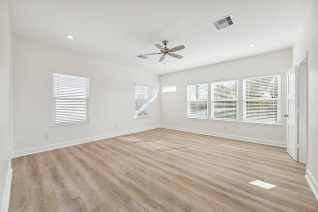 spare room with light wood-type flooring and ceiling fan