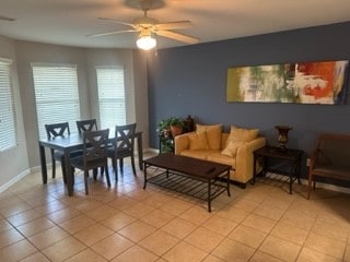 living room featuring ceiling fan and light tile patterned flooring