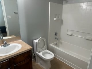 full bathroom featuring vanity, toilet, and tub / shower combination