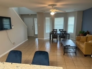 tiled living room with ceiling fan