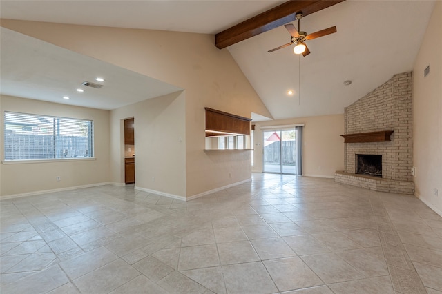 unfurnished living room featuring ceiling fan, beamed ceiling, high vaulted ceiling, a fireplace, and light tile patterned floors