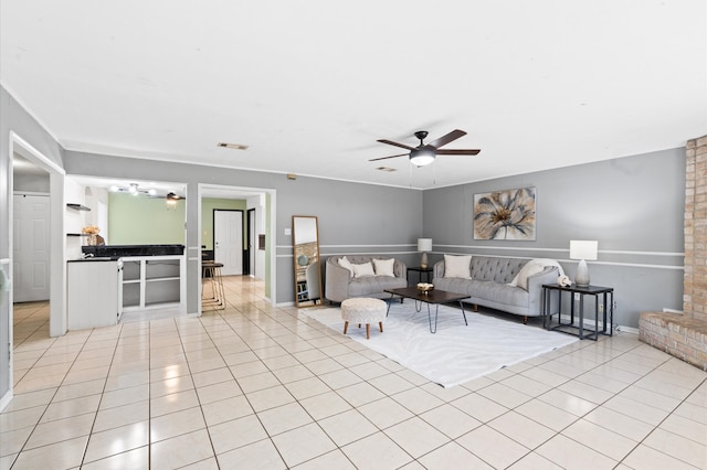 unfurnished living room featuring ceiling fan and light tile patterned floors