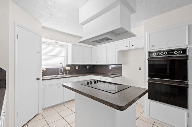 kitchen with sink, premium range hood, white cabinetry, and black appliances